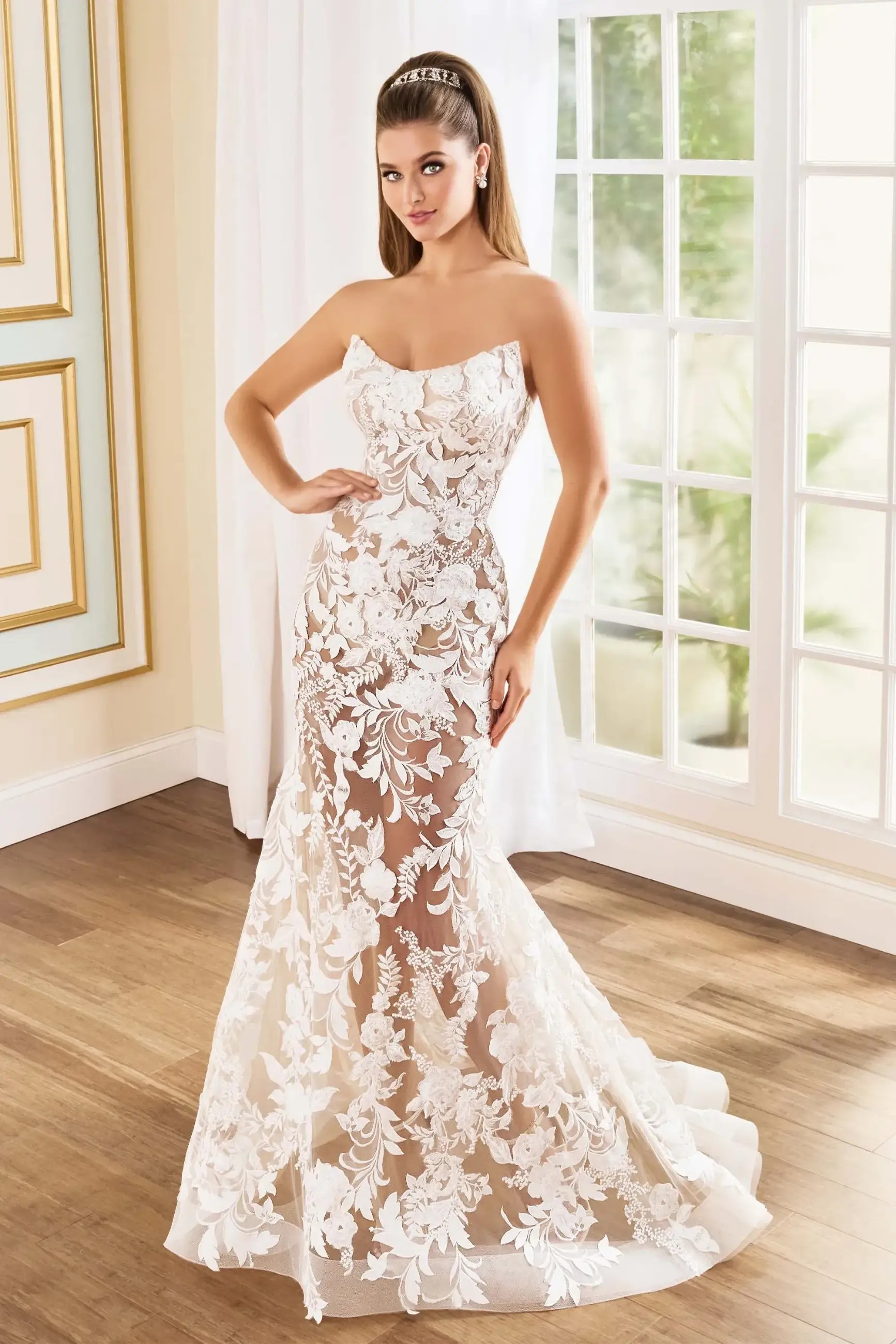 Model is wearing a mermaid bridal gown with a long train by martin thornburg